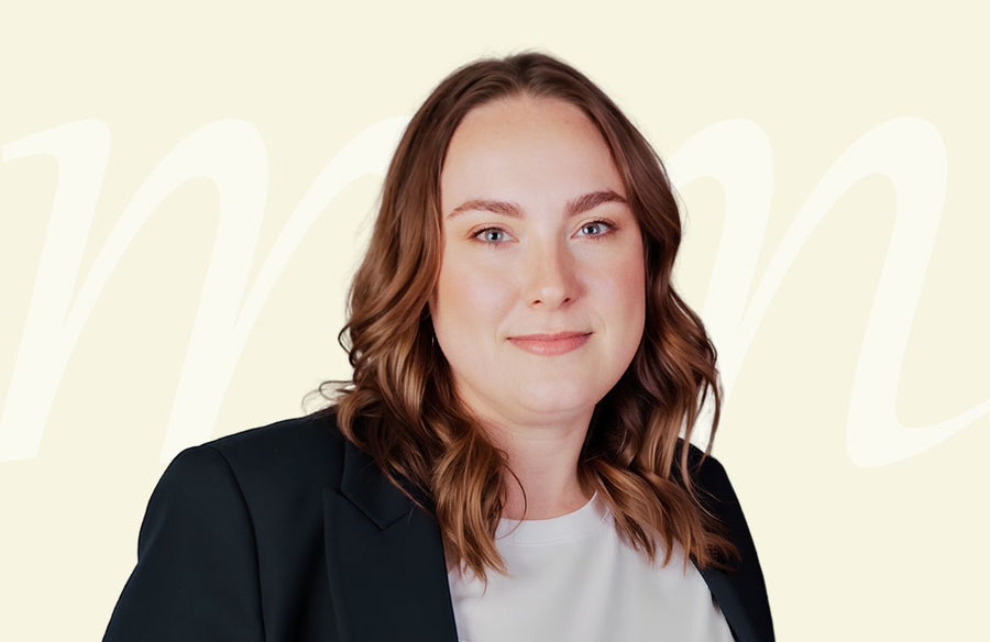 A person wearing a black blazer over a white top against a plain background with the word TYPO3 repeated.