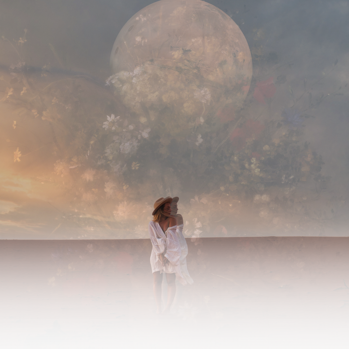 A couple embraces in front of a large, illuminated balloon covered in floral patterns at sunset.
