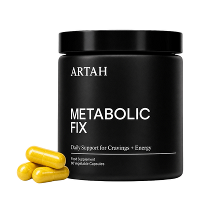 A black cylindrical supplement jar labeled ARTAH METABOLIC FIX with three yellow capsules placed in front on a white background.