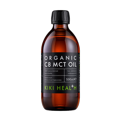 A 500ml amber glass bottle of Kiki Health Organic C8 MCT Oil with a black ribbed cap and a black label featuring white and green text.