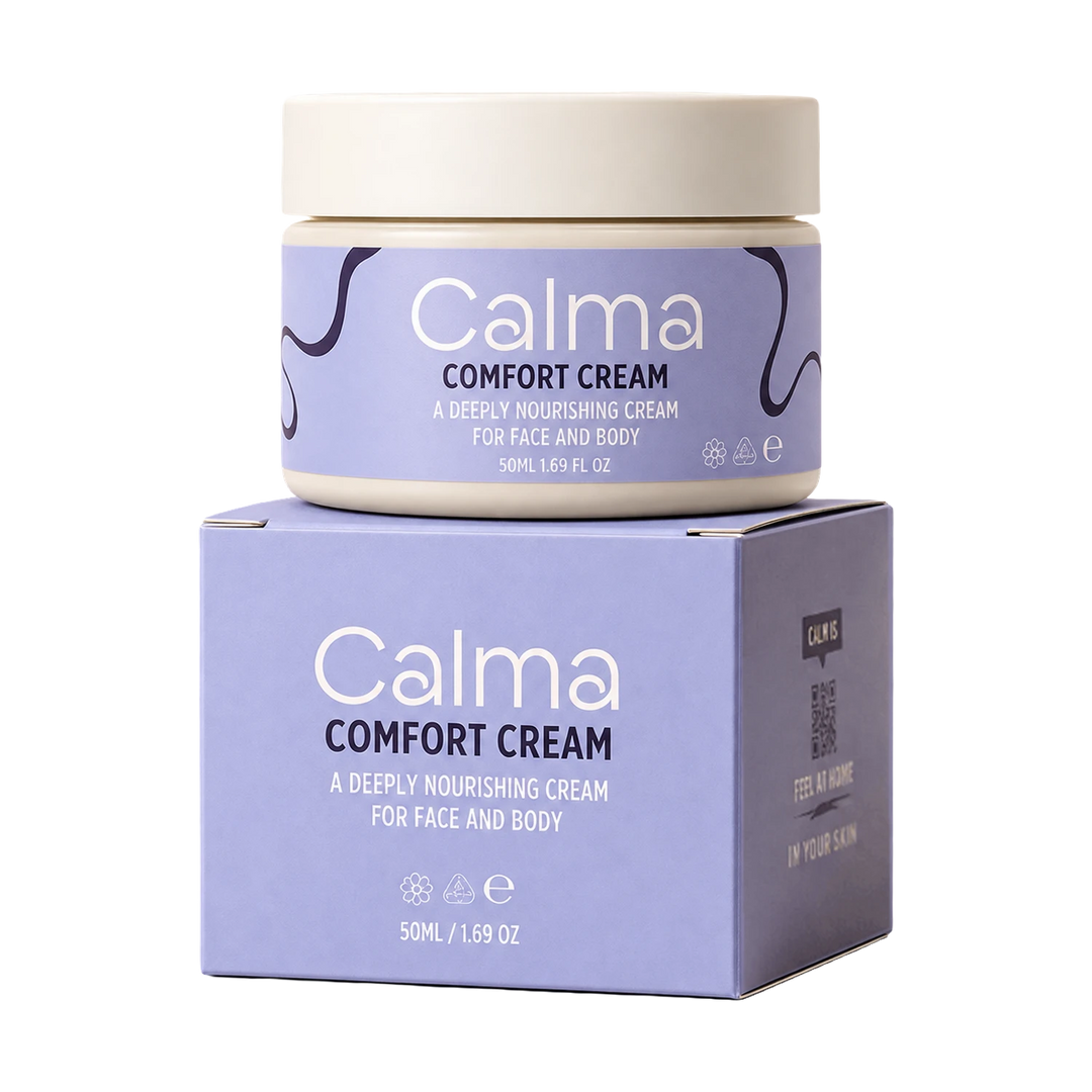 A jar of Calma Comfort Cream sits on top of its matching product box against a plain white background. The packaging features a lavender-purple label with white text and dark purple abstract line details, and a cream-colored lid and base.