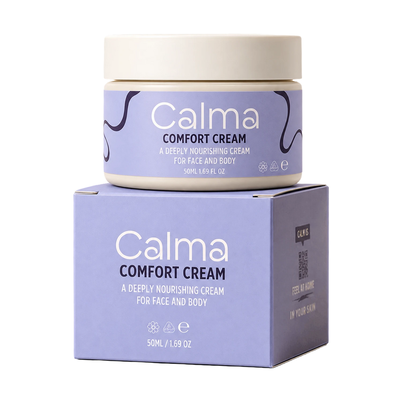 A jar of Calma Comfort Cream sits on top of its matching product box against a plain white background. The packaging features a lavender-purple label with white text and dark purple abstract line details, and a cream-colored lid and base.