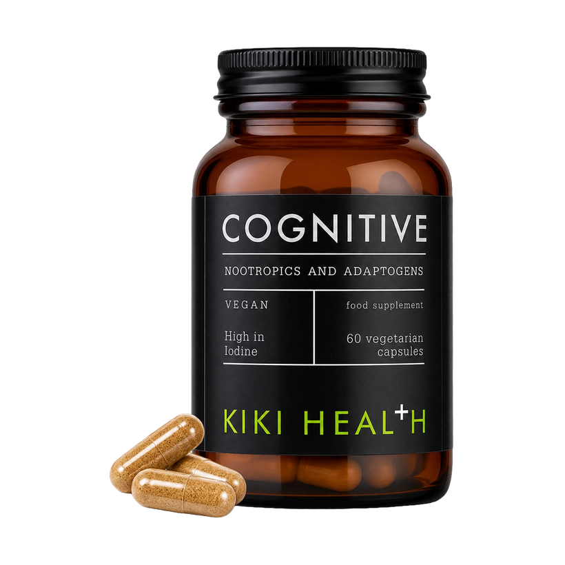An amber glass supplement bottle labeled 'COGNITIVE' by Kiki Health, with three tan capsules placed in front on a clean white background.
