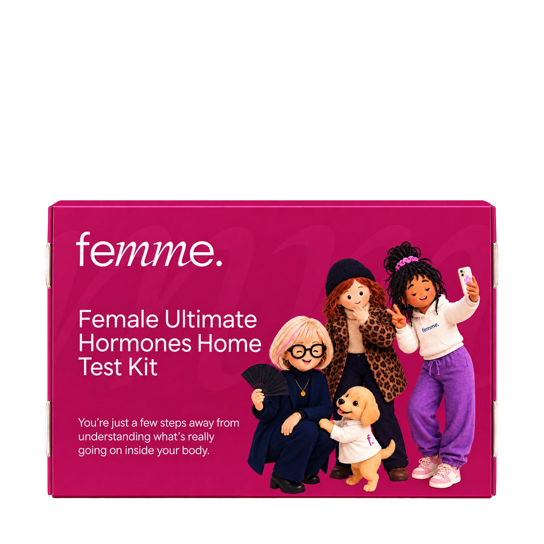 A bright pink rectangular product box for the femme Female Ultimate Hormones Home Test Kit, featuring white text and an illustration of four dolls and a small dog on the front.