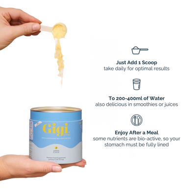 A hand holds a canister of Gigi Probiotic Balance Blend powder, with a scoop of the yellow powder being lifted above it. Text on the right explains how to use the product: add one scoop daily, mix with 200-400ml of water, and enjoy after a meal.