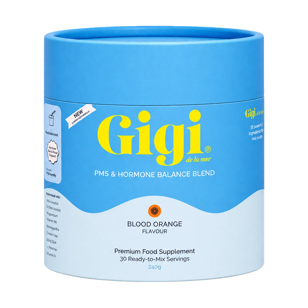 A blue cylindrical canister of Gigi de la mar PMS & Hormone Balance Blend in Blood Orange flavor, shown on a plain white background.