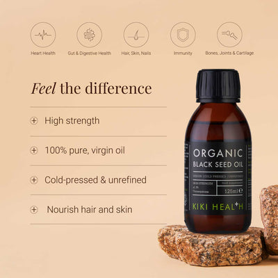 Black Seed Oil bottle with product benefits on a beige background