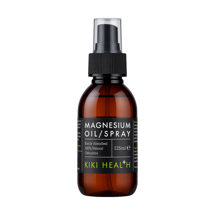 A 125ml amber glass bottle of Kiki Health Magnesium Oil Spray with a black spray nozzle and a black label featuring green brand text, set against a plain white background.