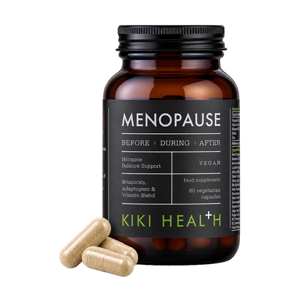 An amber supplement bottle labeled 'MENOPAUSE' by Kiki Health+ with three beige capsules placed in front on a clean white background.