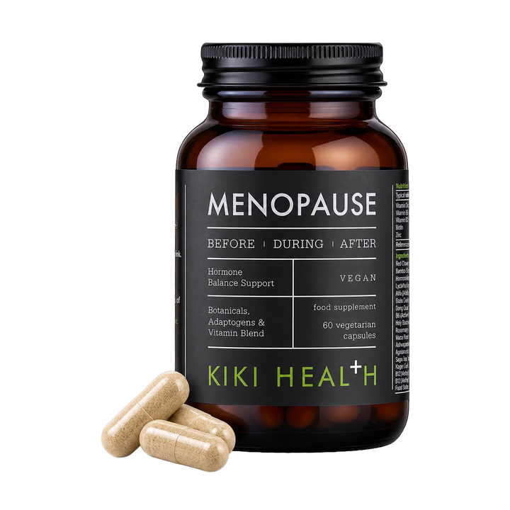 An amber supplement bottle labeled 'MENOPAUSE' by Kiki Health+ with three beige capsules placed in front on a clean white background.