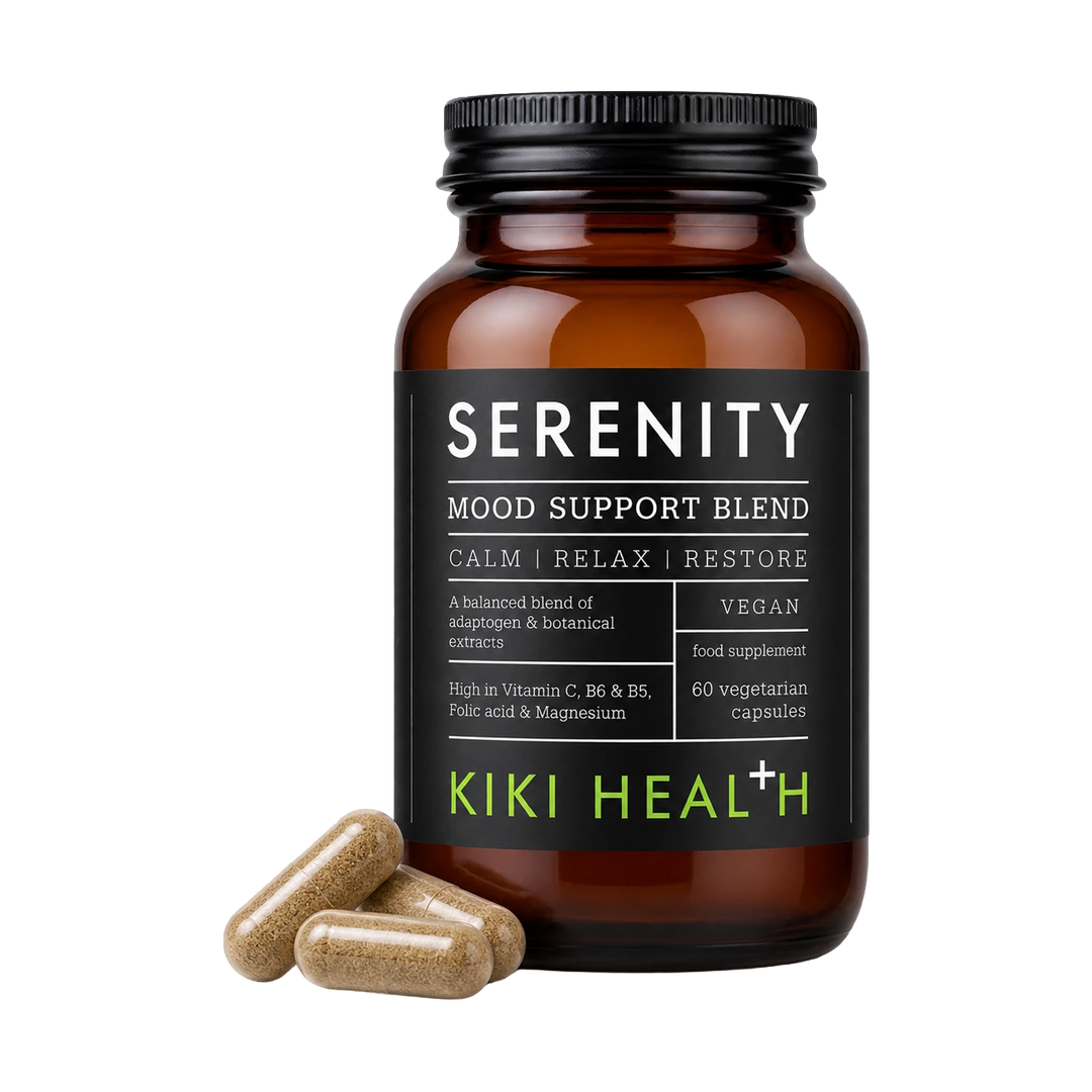 An amber glass supplement bottle labeled 'SERENITY MOOD SUPPORT BLEND' by Kiki Health, with three tan capsules placed in front on a clean white background.
