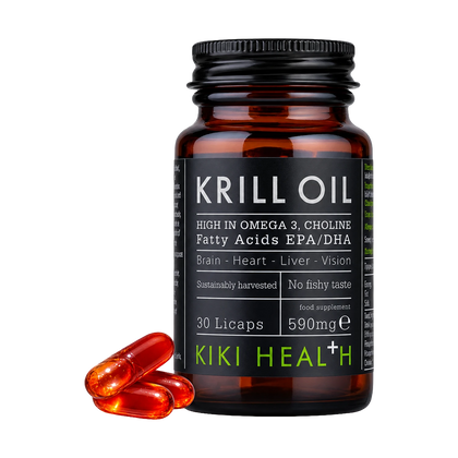 A bottle of Kiki Health+ Krill Oil capsules with three capsules beside it.