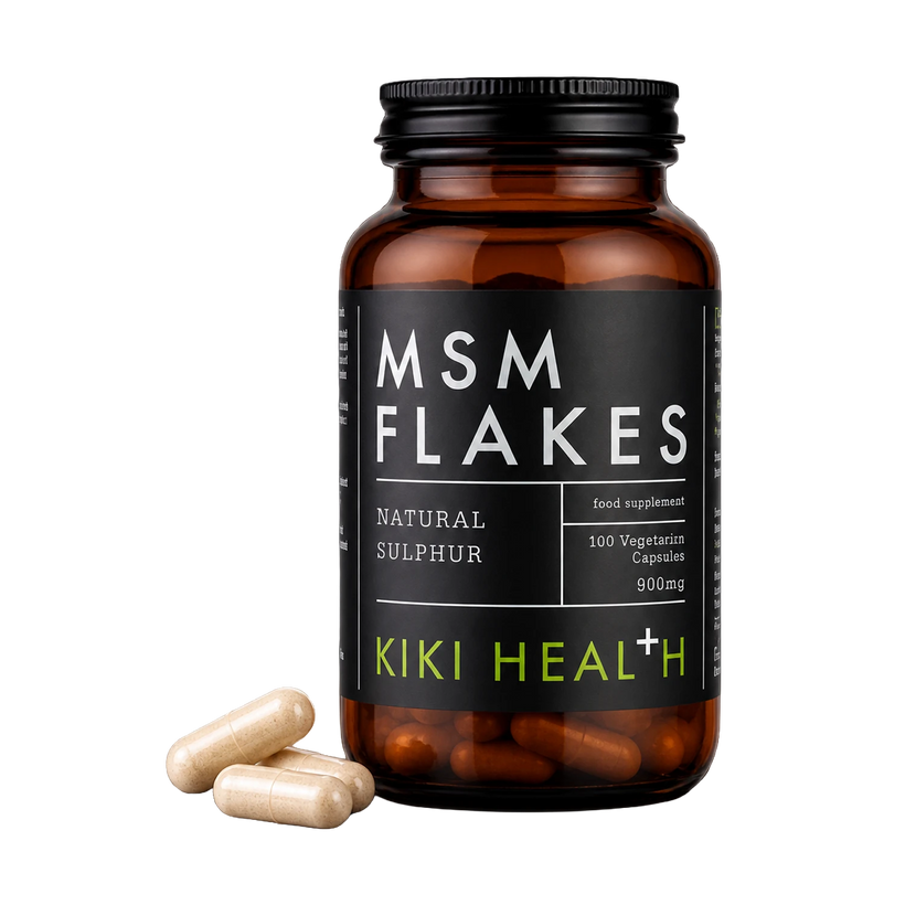An amber supplement bottle labeled MSM FLAKES by Kiki Health+ with three beige capsules placed in front, on a clean white background.