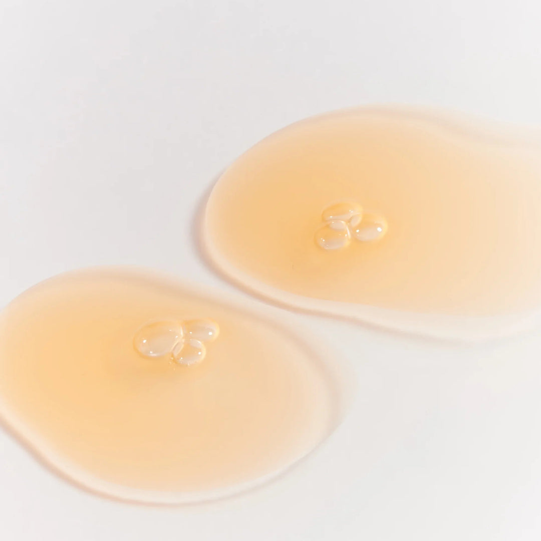 Two droplets of muihood rice water on a white background