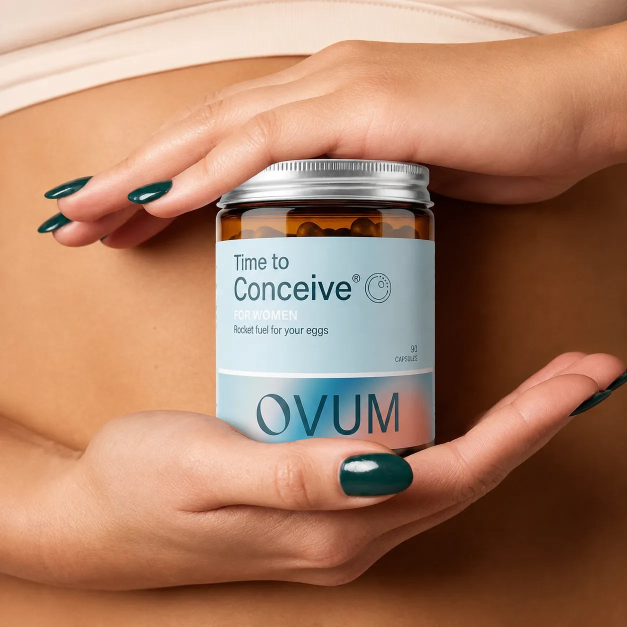 A close-up of a pregnant woman's hands holding an amber glass bottle of OVUM 'Time to Conceive' capsules against her stomach.
