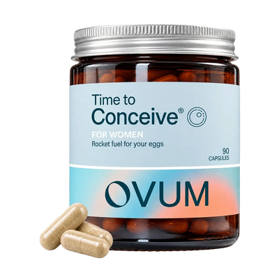 A jar of OVUM 'Time to Conceive' dietary supplement capsules on a white background, with three beige capsules placed in front of the jar.