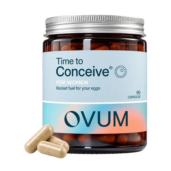 A jar of OVUM 'Time to Conceive' dietary supplement capsules on a white background, with three beige capsules placed in front of the jar.