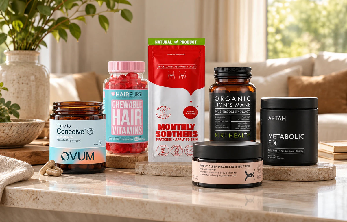 Six different supplement products displayed on a bathroom countertop including Time to Conceive Ovum capsules, Hairburst Chewable Hair Vitamins, Monthly Soother