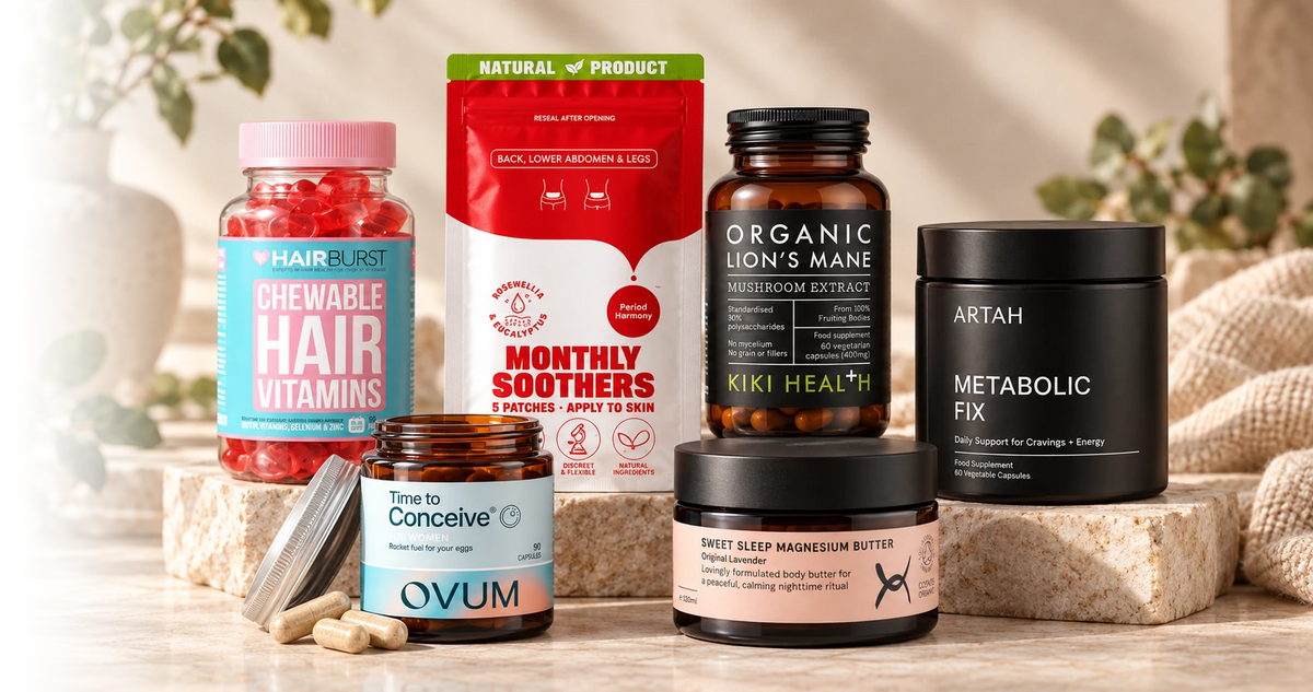Six different supplement products arranged on stone blocks including Hairburst Chewable Hair Vitamins, Monthly Soothers patches, Organic Lion's Mane mushroom ex