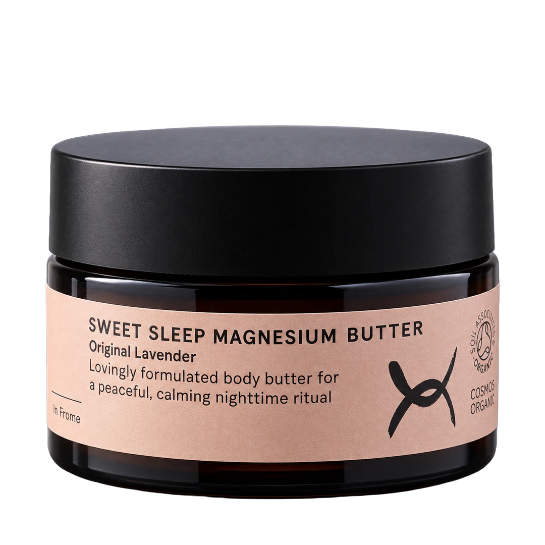 A dark amber glass jar of 'Sweet Sleep Magnesium Butter' with a matte black lid and a light pink label, shown on a solid white background.
