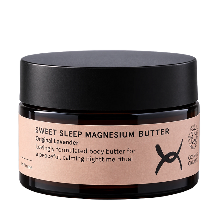 A dark amber glass jar of 'Sweet Sleep Magnesium Butter' with a matte black lid and a light pink label, shown on a solid white background.