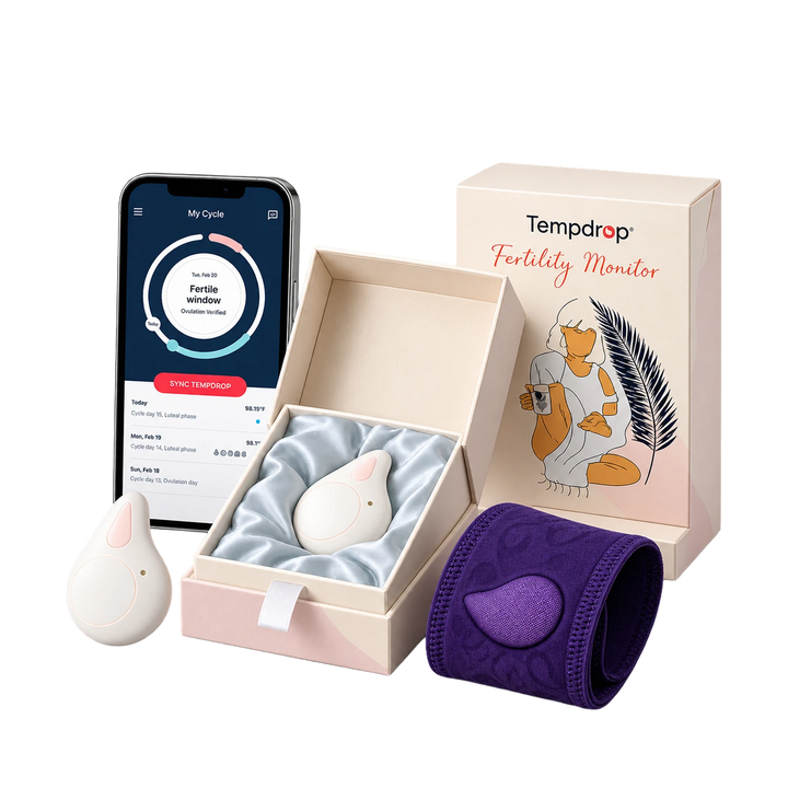 Tempdrop fertility monitor set including a white egg-shaped tracker, a purple cuff, a smartphone app screen, and branded gift box on a white background.