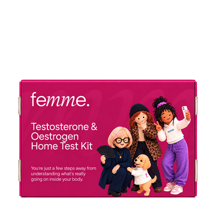 A bright pink rectangular product box for the femme Testosterone & Oestrogen Home Test Kit, shown on a plain white background. The box features white text and an illustration of four cartoon women and a small dog in stylish outfits.