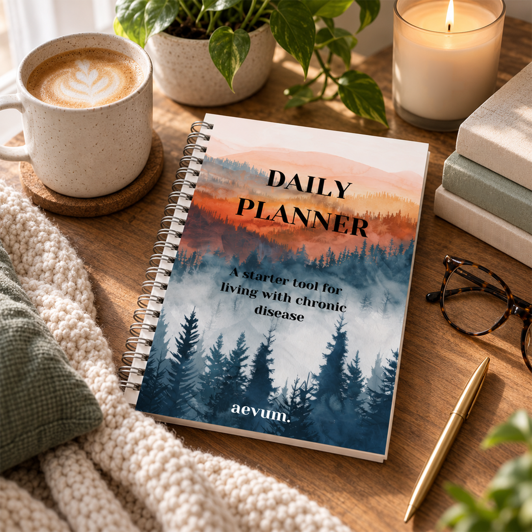 A Daily Planner titled A starter tool for living with chronic disease by aevum on a wooden table with plants, candles, mugs and glasses.