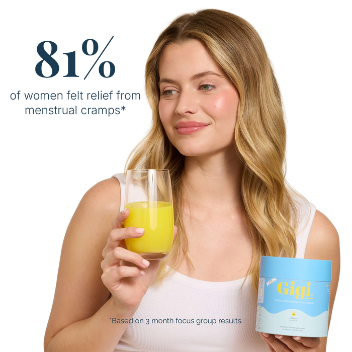 Woman holding a glass and Gigi supplement with information about menstrual cramp relief.